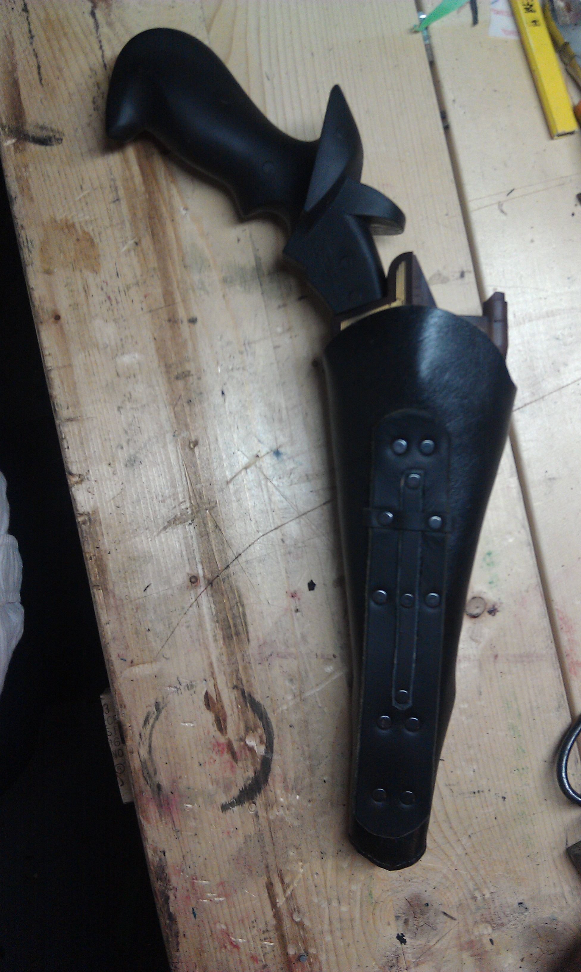 Black disruptor holster.  There is a lace to tie it to the leg, and hooks for a chain baldric.  The house of Martok symbol was added after the custome