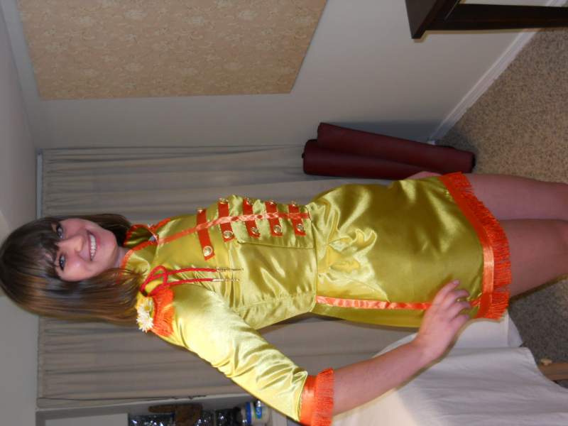 Kalina in the form fitting mini dress version of the John Sgt Pepper suit