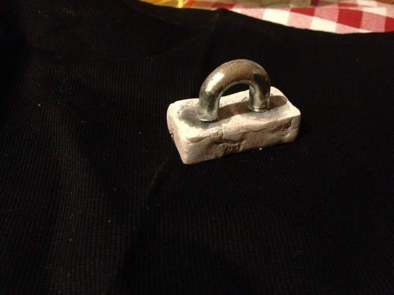 One of the chain attachments, there are two magnets in the casting that allow the chain to disconnect if pulled too hard.